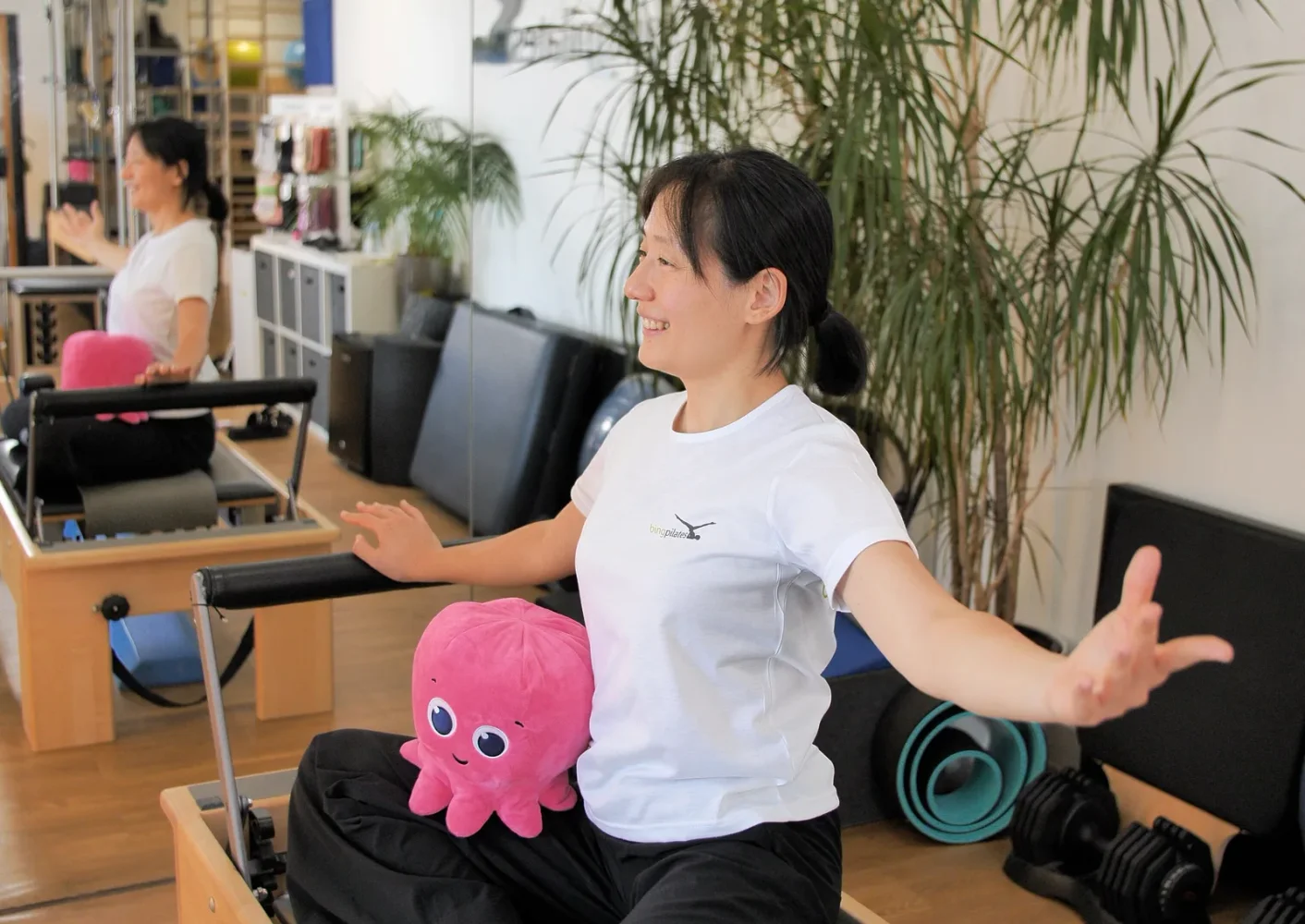A person with an Octopus Energy mascot in the Bing Pilates studio.