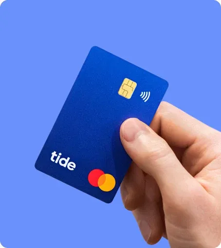 A blue Tide debit card held against a blue background.